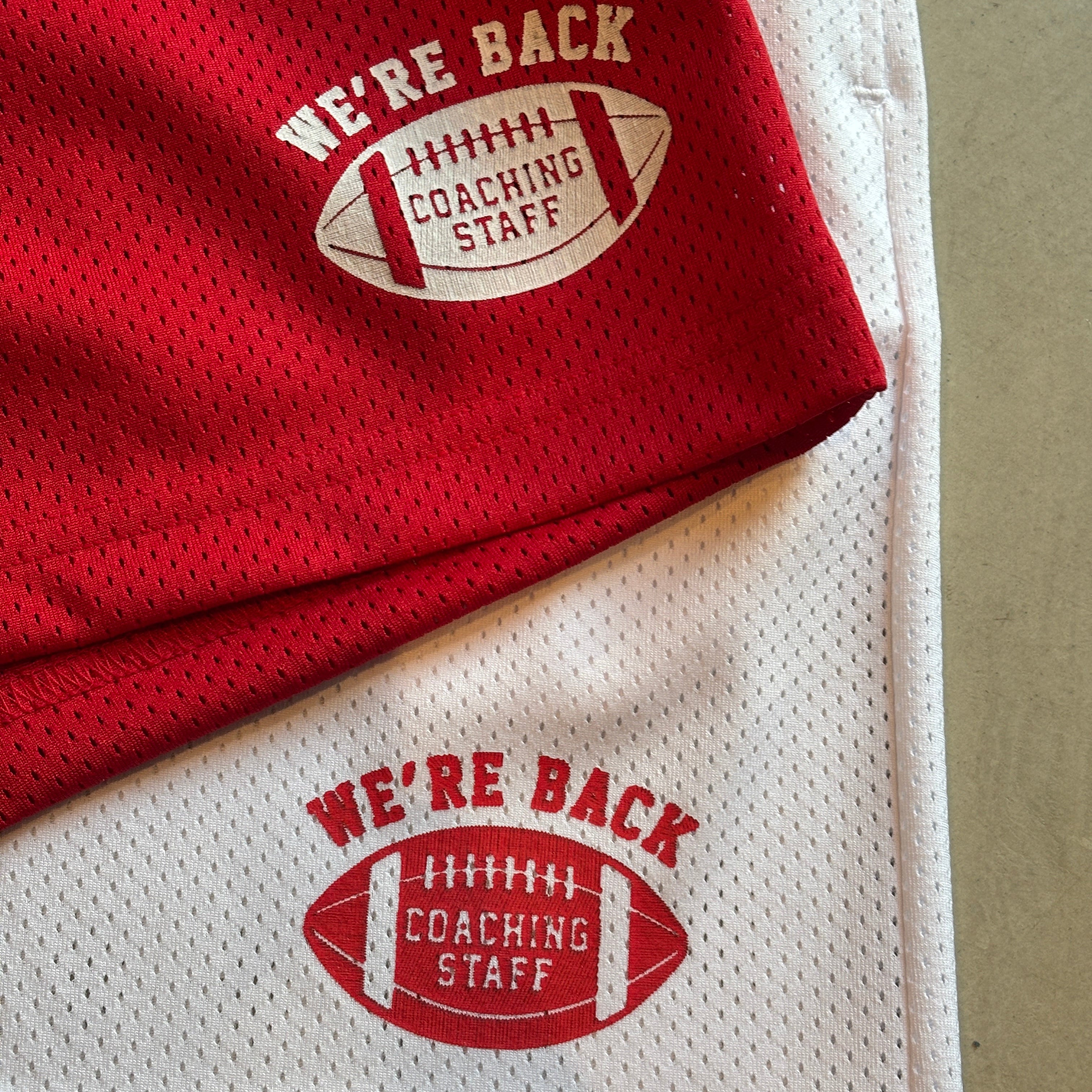 Red and white sports jerseys with 'We're Back' text and football graphic on a beige background