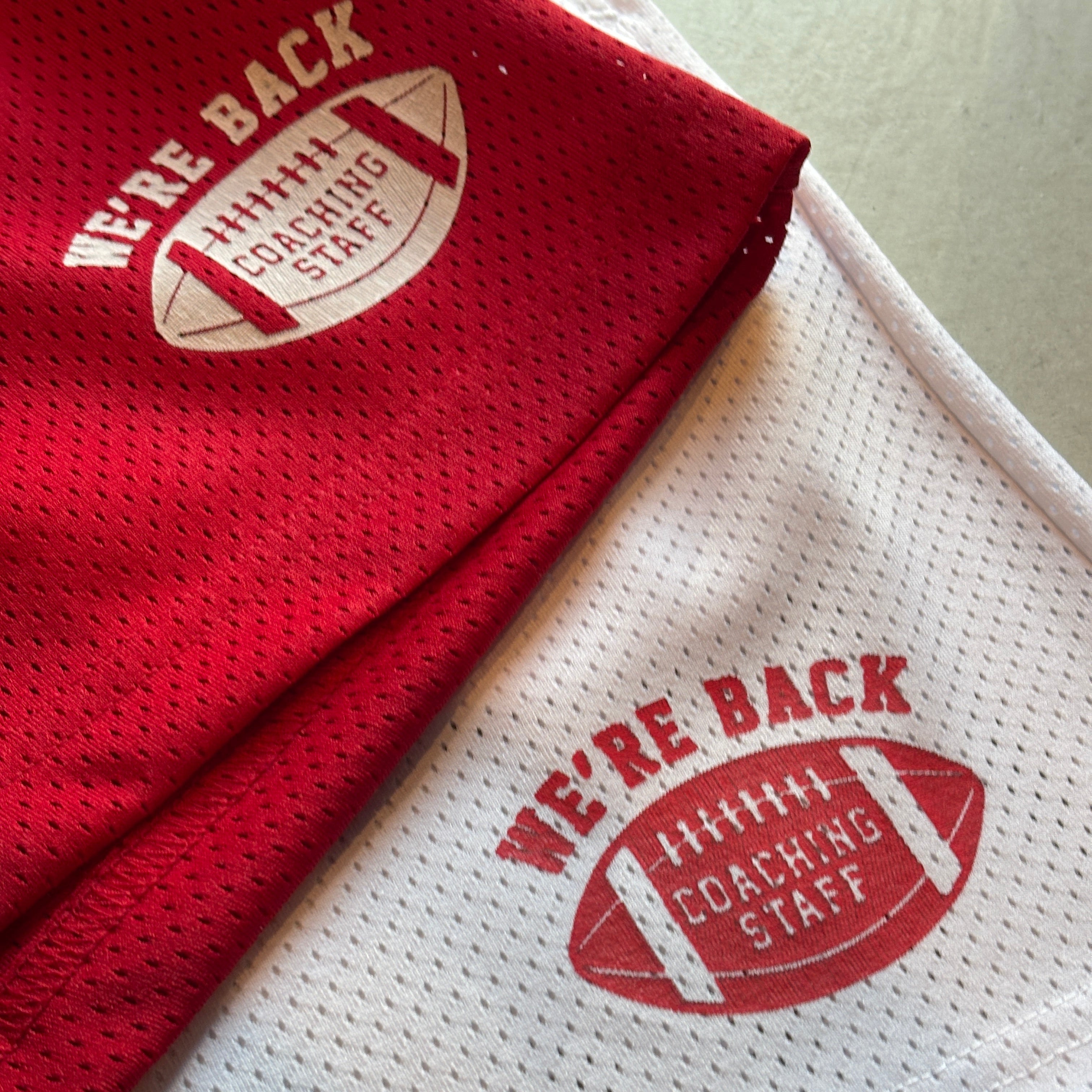 Red and white sports jersey with 'Wear Back' logo on a light background