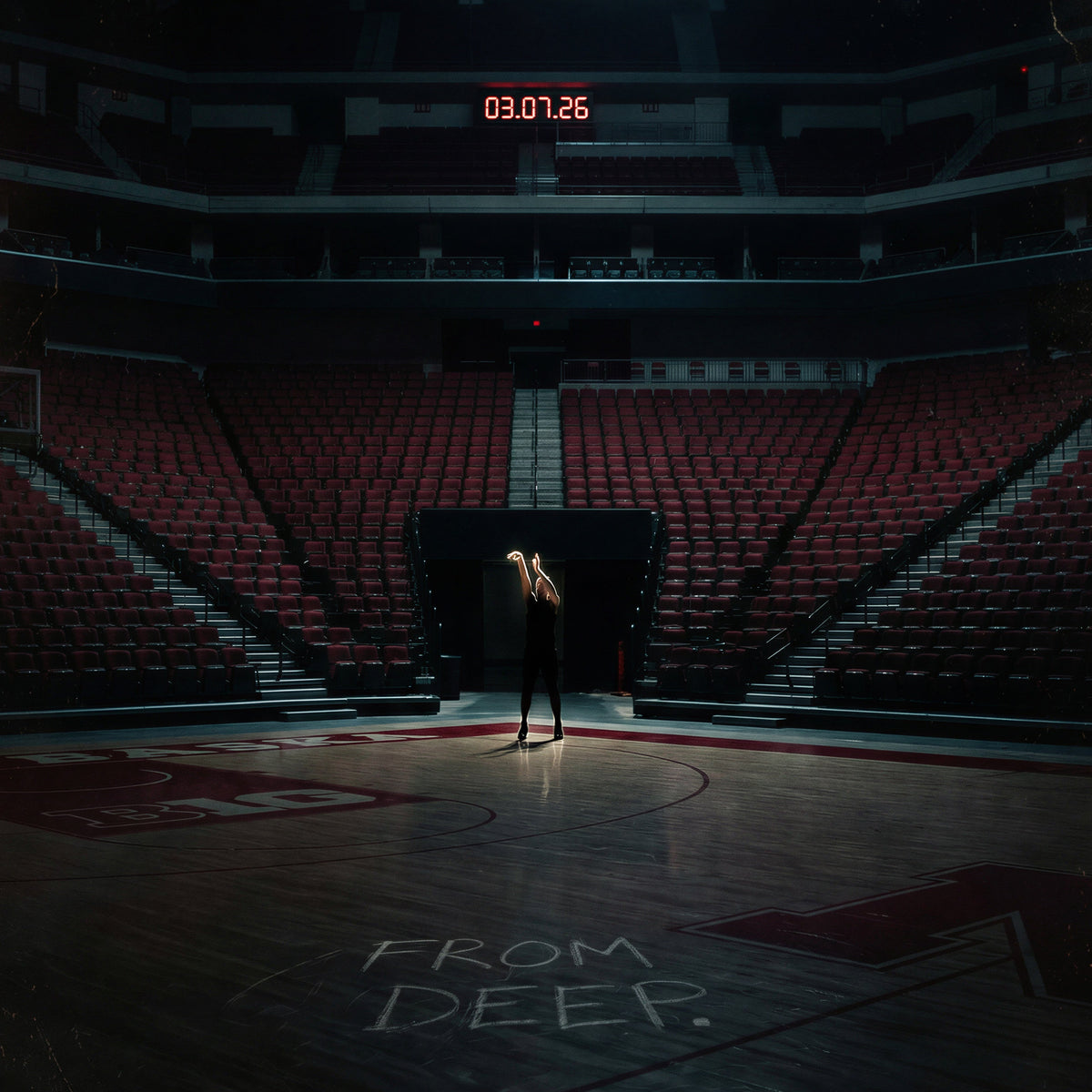 Person standing on a basketball court with 'From Deep' written on the floor, in a darkly lit arena.