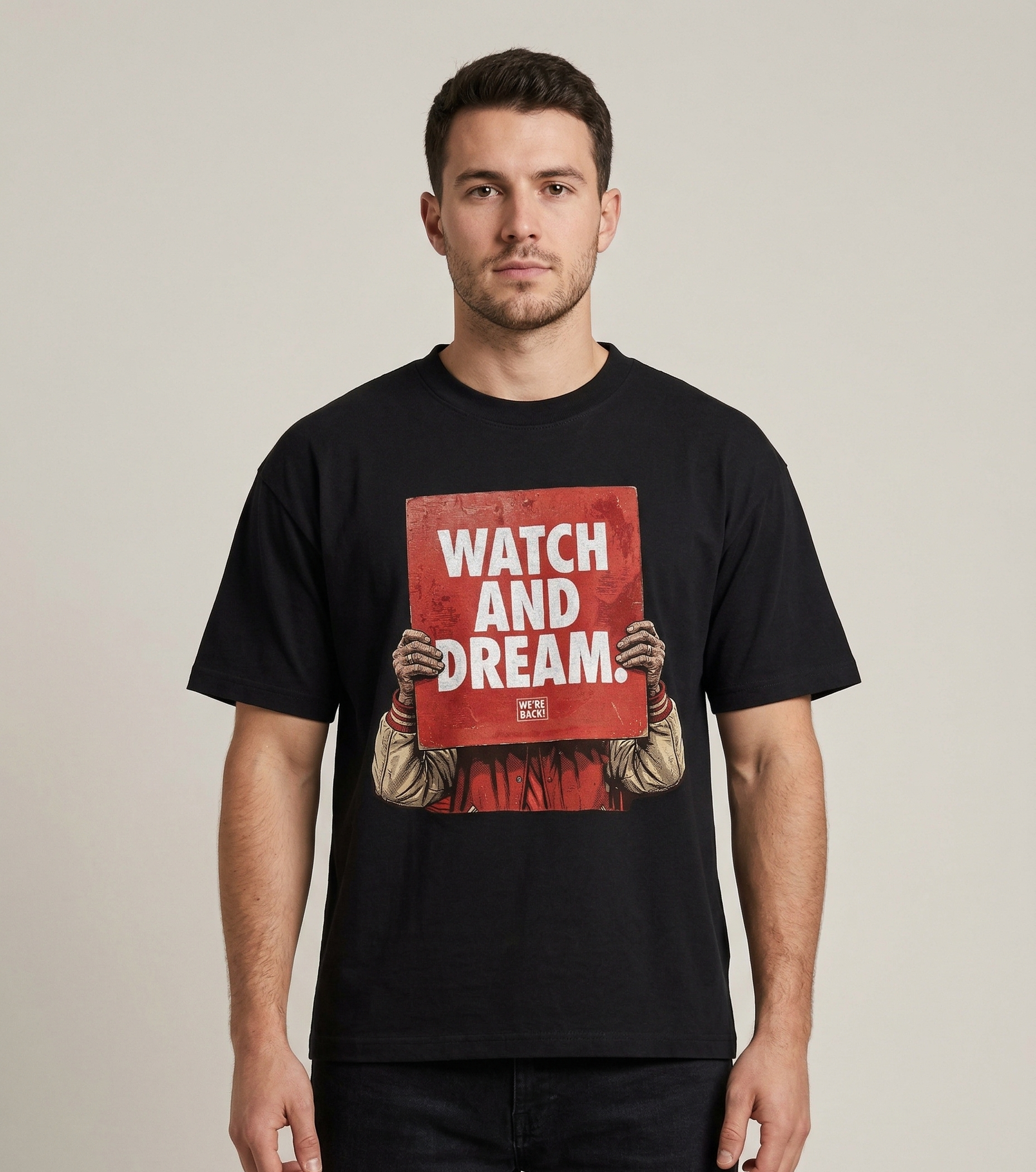 Man wearing a black t-shirt with a graphic design and text on a beige background