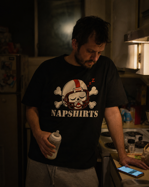 Man in the Napshirts adult tee in a kitchen at two in the morning