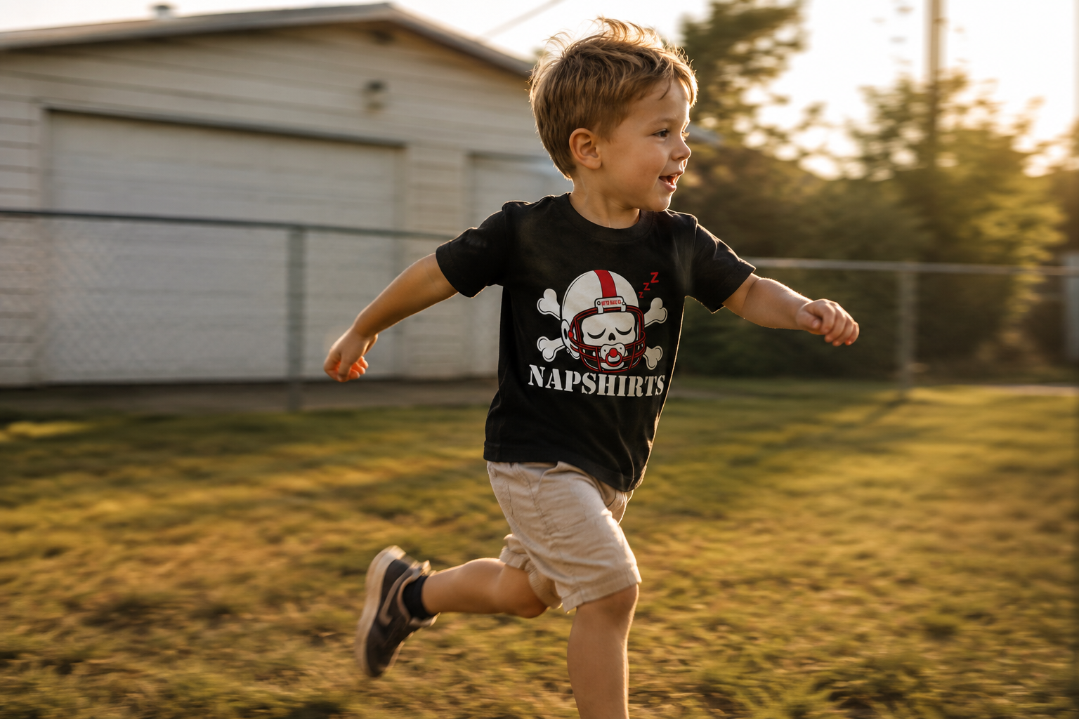 Toddler running across a backyard in the Napshirts toddler tee
