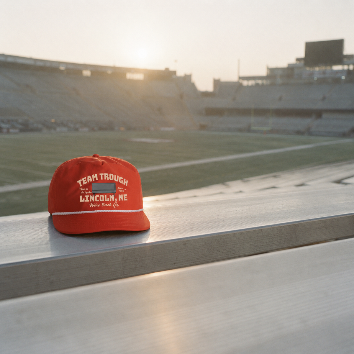 Team Trough rope cap on a bleacher at sunrise