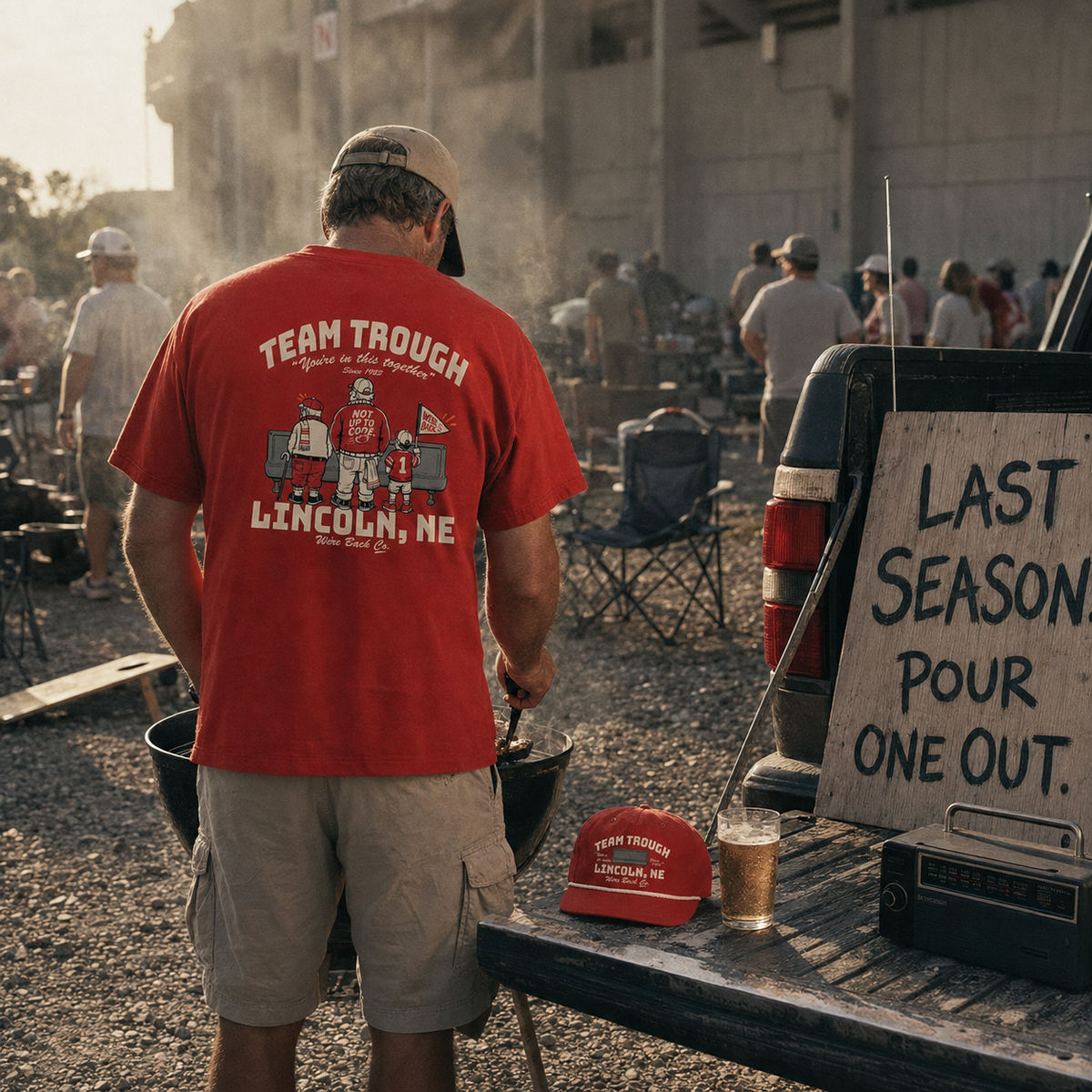 Tailgate scene: Team Trough tee and rope cap, last season sign