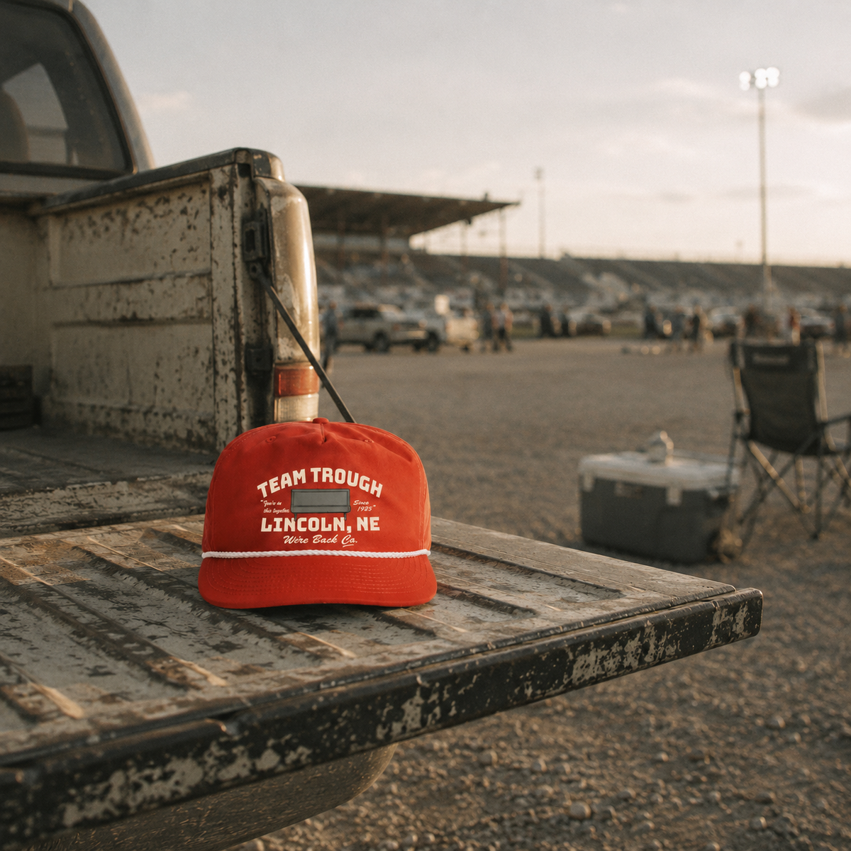 Team Trough rope cap on a truck tailgate outside the stadium